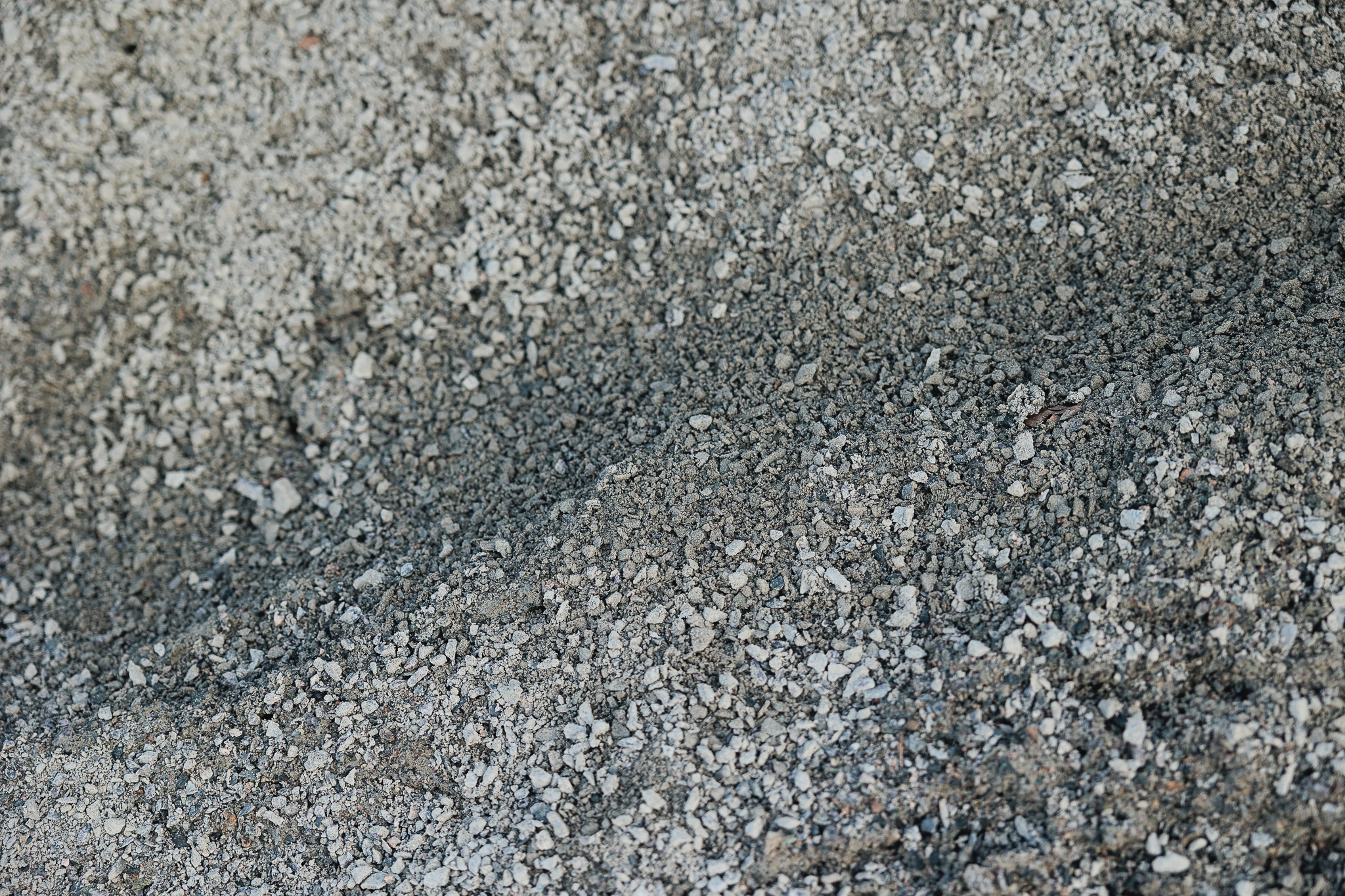 Crushed rock base material, often used in landscaping and as a foundation for pavers and driveways